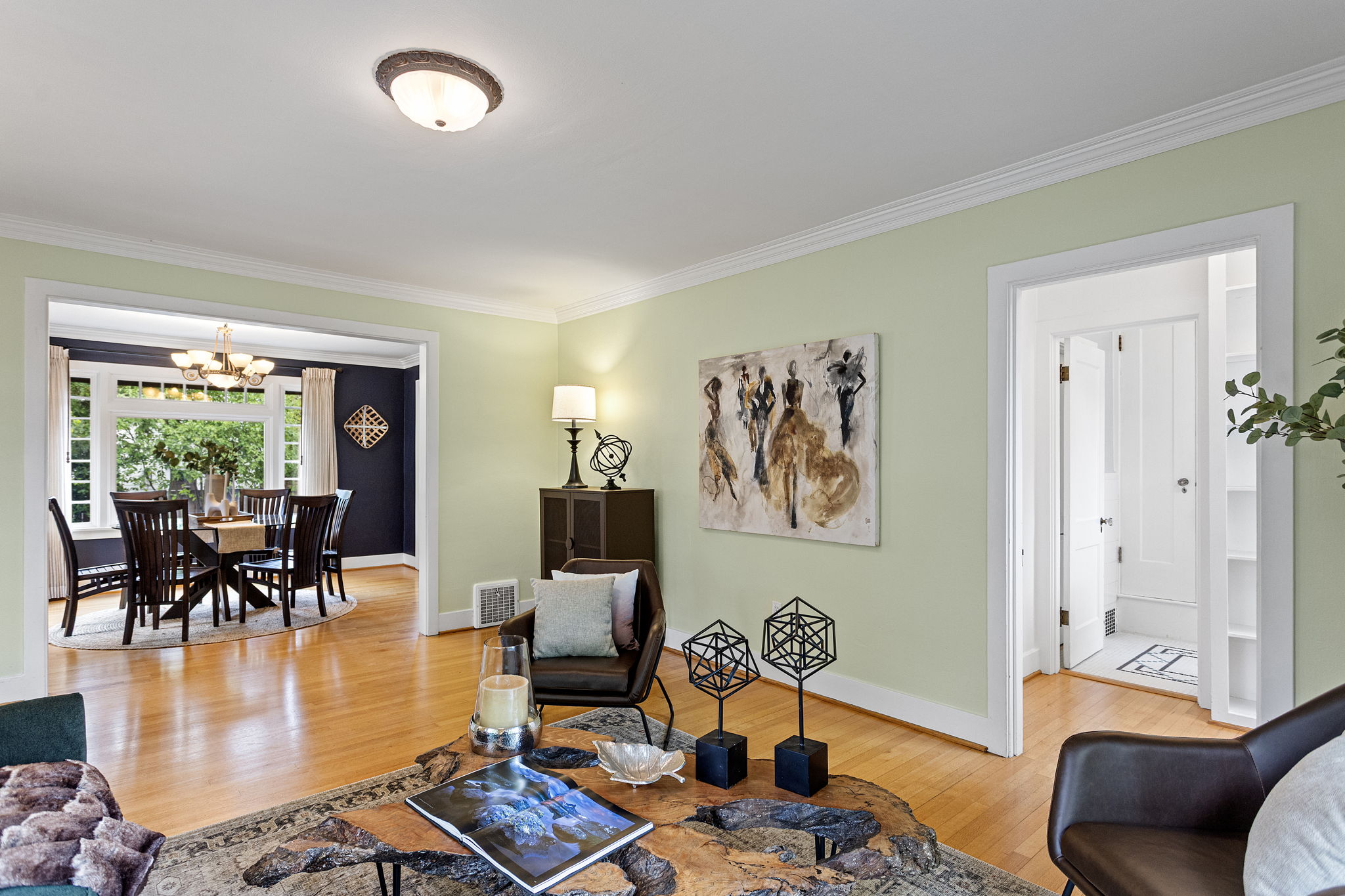 The floors keep going. Dining room left, bath right, stairway ahead — the house is just getting started.
