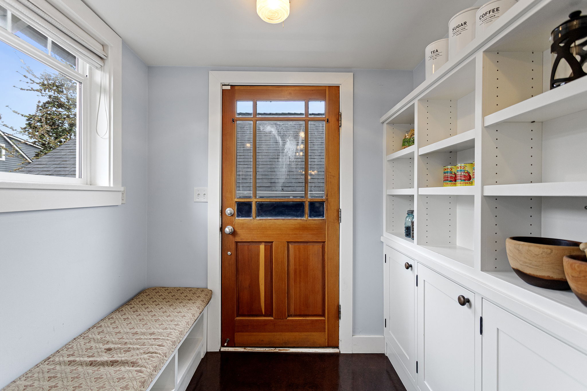 Divided lite Craftsman back door, built-in bench, floor-to-ceiling pantry. Everything you need before you hit the deck.