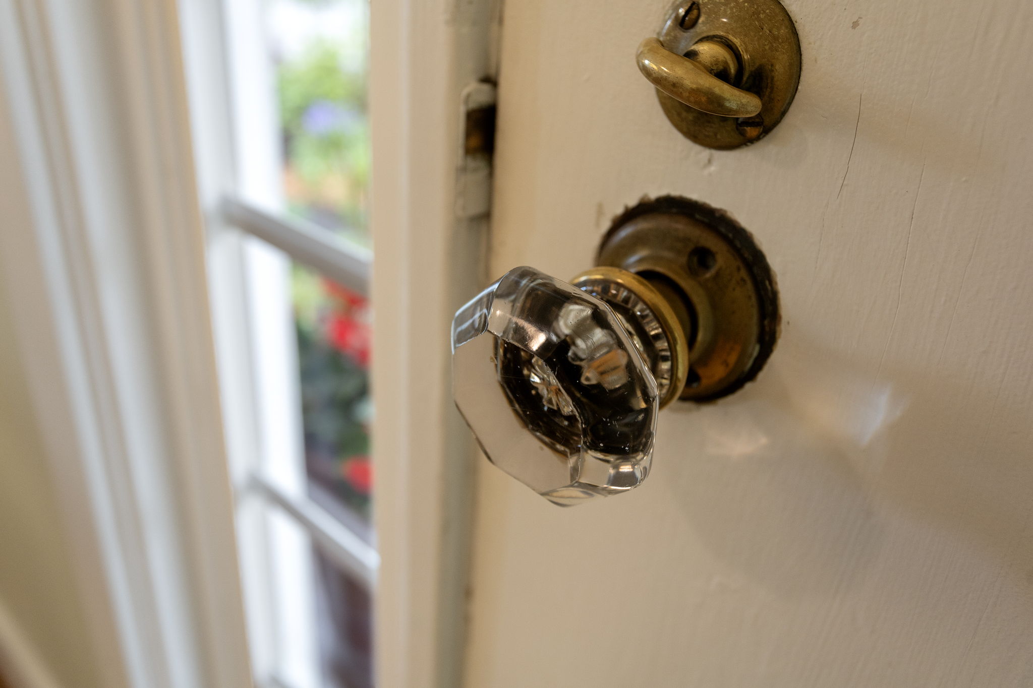 Original glass knobs, brass hardware, faceted octagonal glass. Still here, still working.