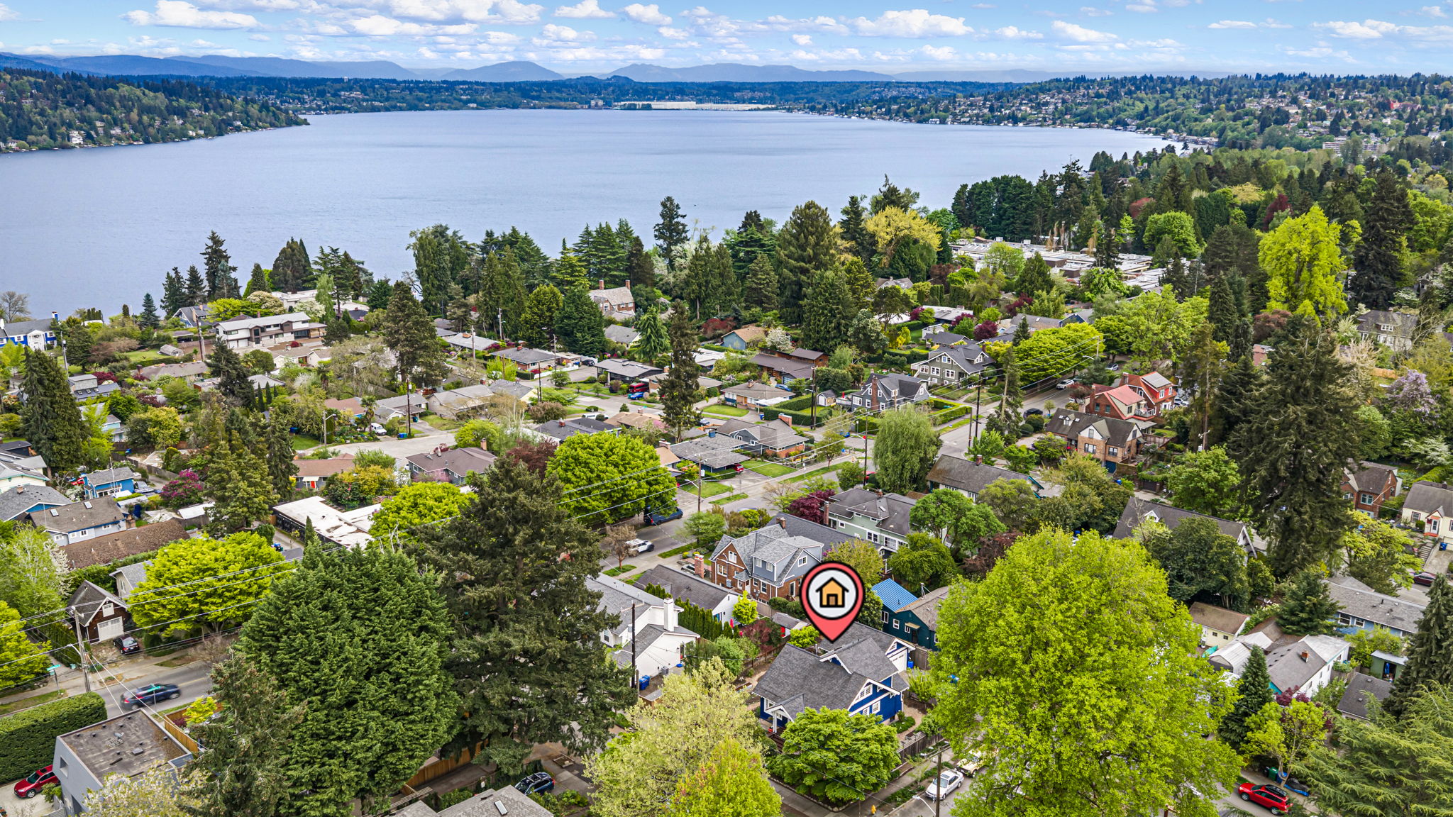 The Seward Park Life: Looking east over the canopy toward the shimmering expanse of Lake Washington. This hilltop retreat is just a short stroll from the hidden gem of Martha Washington Park, the shoreline at Pritchard Island Beach, and the iconic 300-acre forest and trails of Seward Park itself.