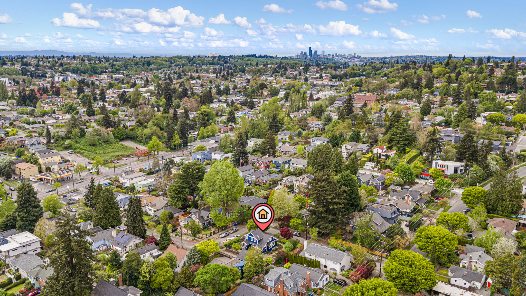 Iconic Northwest Context: A sweeping perspective looking northwest toward the Seattle skyline. This view anchors the historic 1924 Craftsman within the organic, winding character that defines South East Seattle—balancing the pulse of the city with the quiet, park-lined streets that lead home.