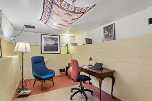 Painted brick walls, painted concrete floor, exterior backyard access. Cool in summer, quiet year-round. The seller used it as an office. The next owner will have opinions.