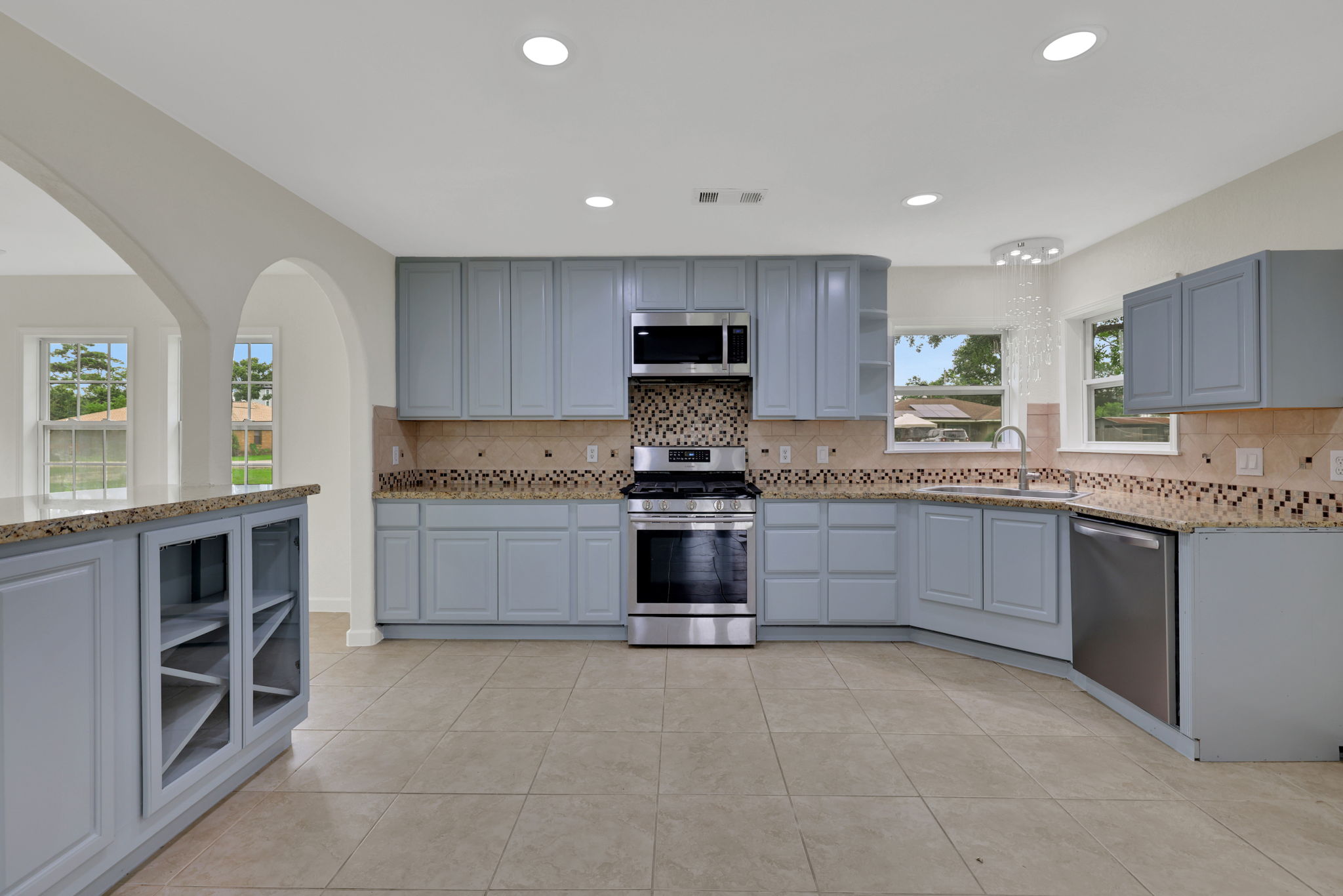 Another view of this spacious kitchen includes additional cabinetry storage drawers, built in wine storage and recessed lighting creating a bright and inviting atmosphere.