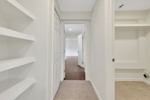 Elongated hallway with built-in shelves for more storage