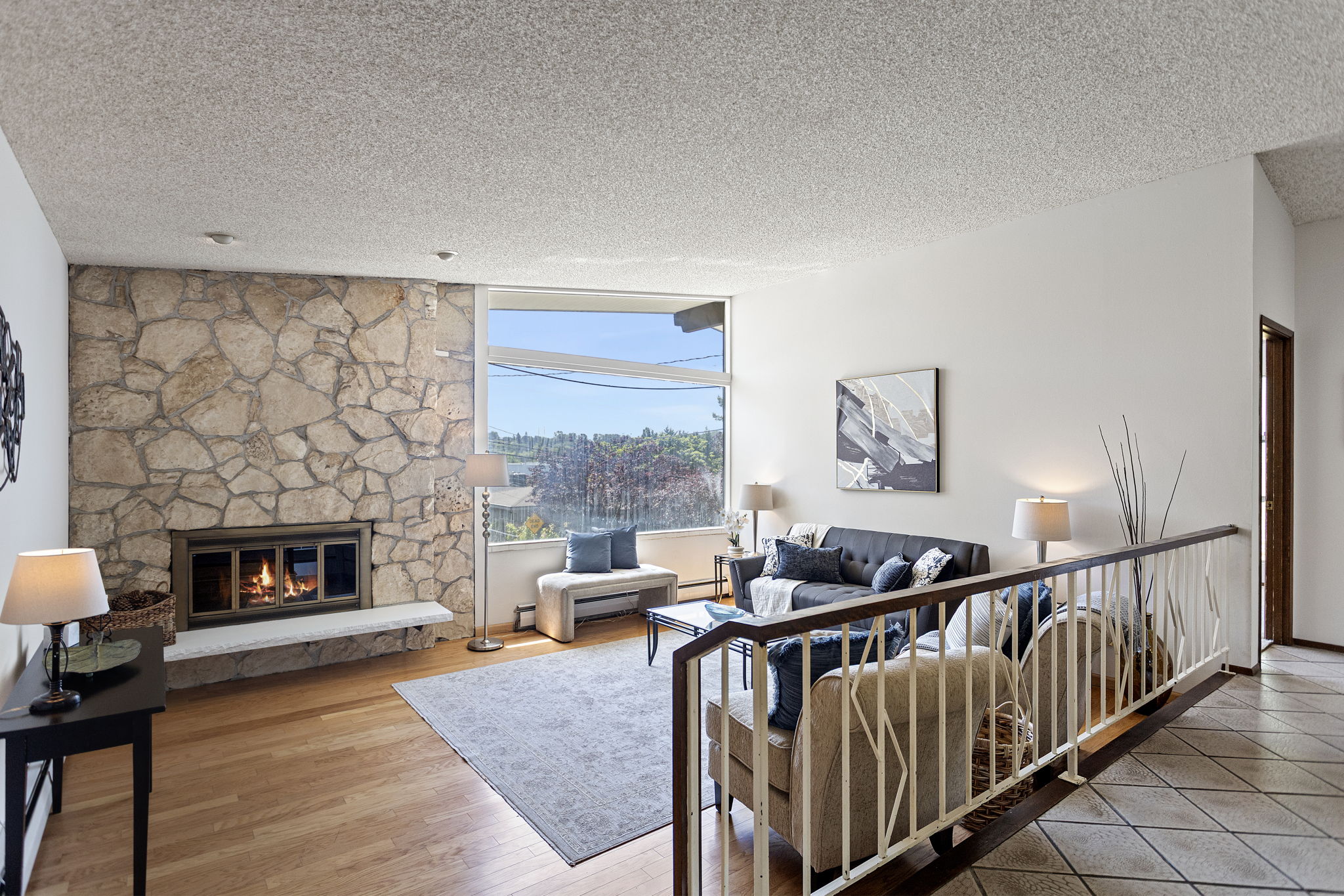Floor-to-ceiling stone, dramatic vaulted ceiling, original iron railing. Sixty years and it's still the best seat in the house.