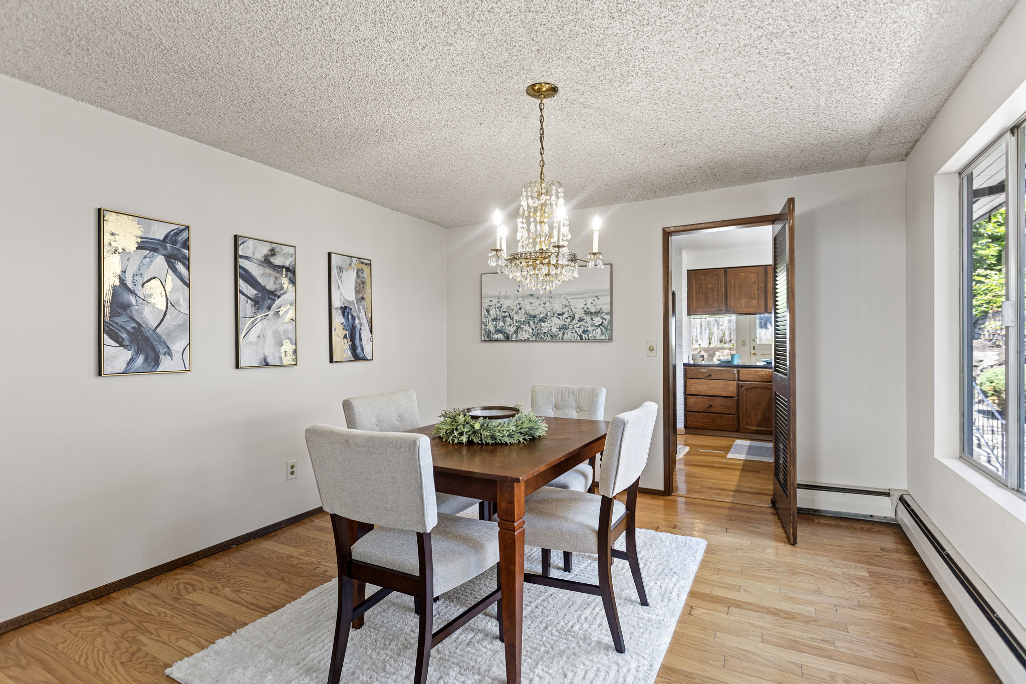Formal dining, hardwood floor, open to the kitchen. The kind of room that gets used.