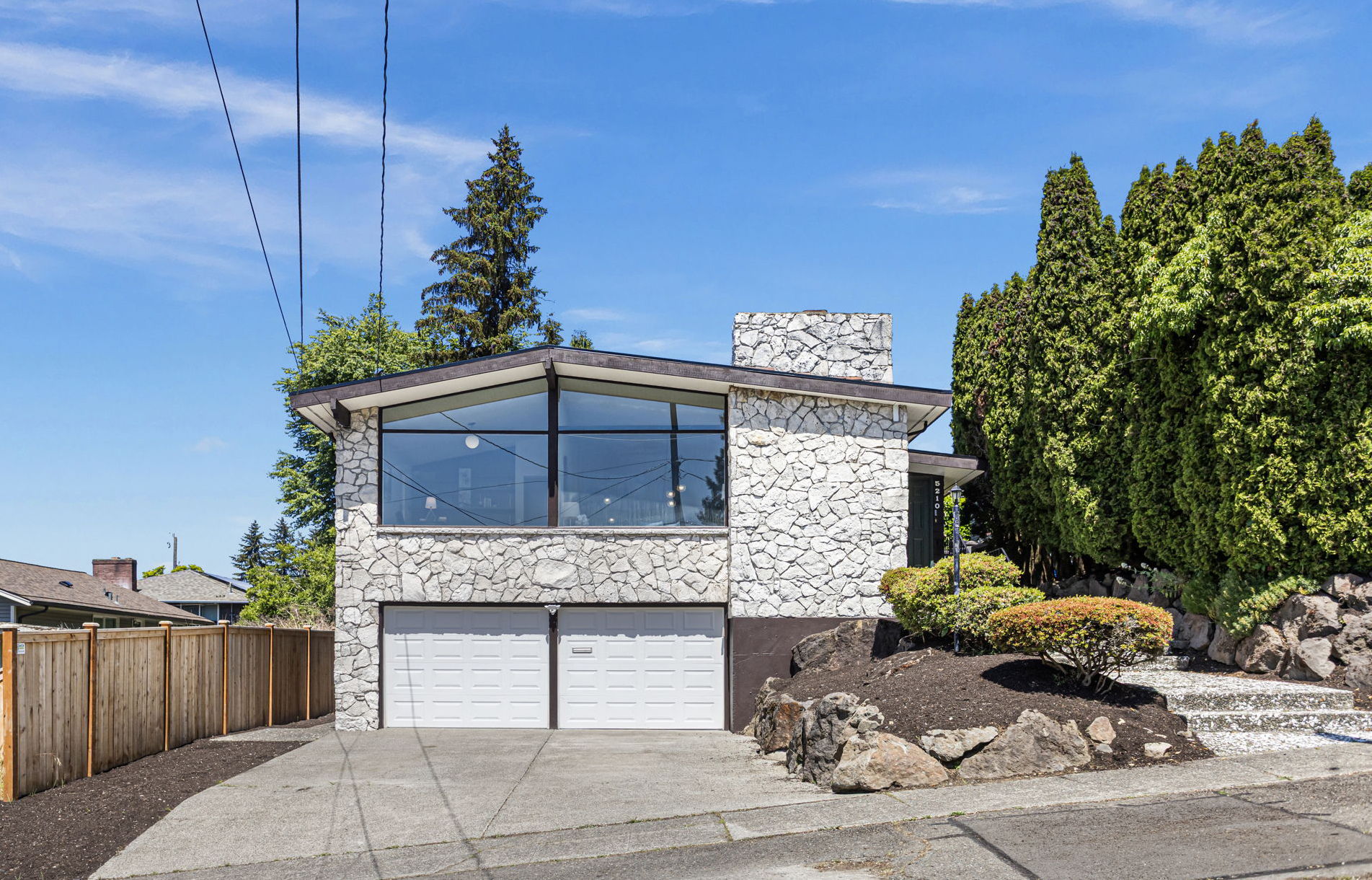 Floor-to-ceiling glass over a 2-car garage. The architecture was always the point.