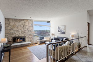 Floor-to-ceiling stone, dramatic vaulted ceiling, original iron railing. Sixty years and it's still the best seat in the house.