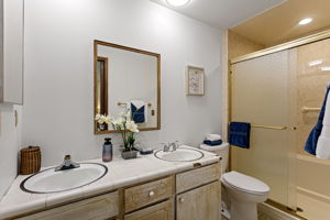 Primary en suite — double sinks, walk-in shower. Ready to shine with modern upgrades and your own vision.