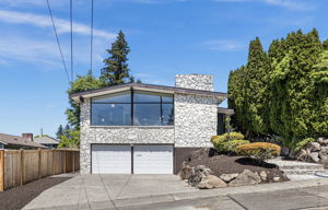Floor-to-ceiling glass over a 2-car garage. The architecture was always the point.