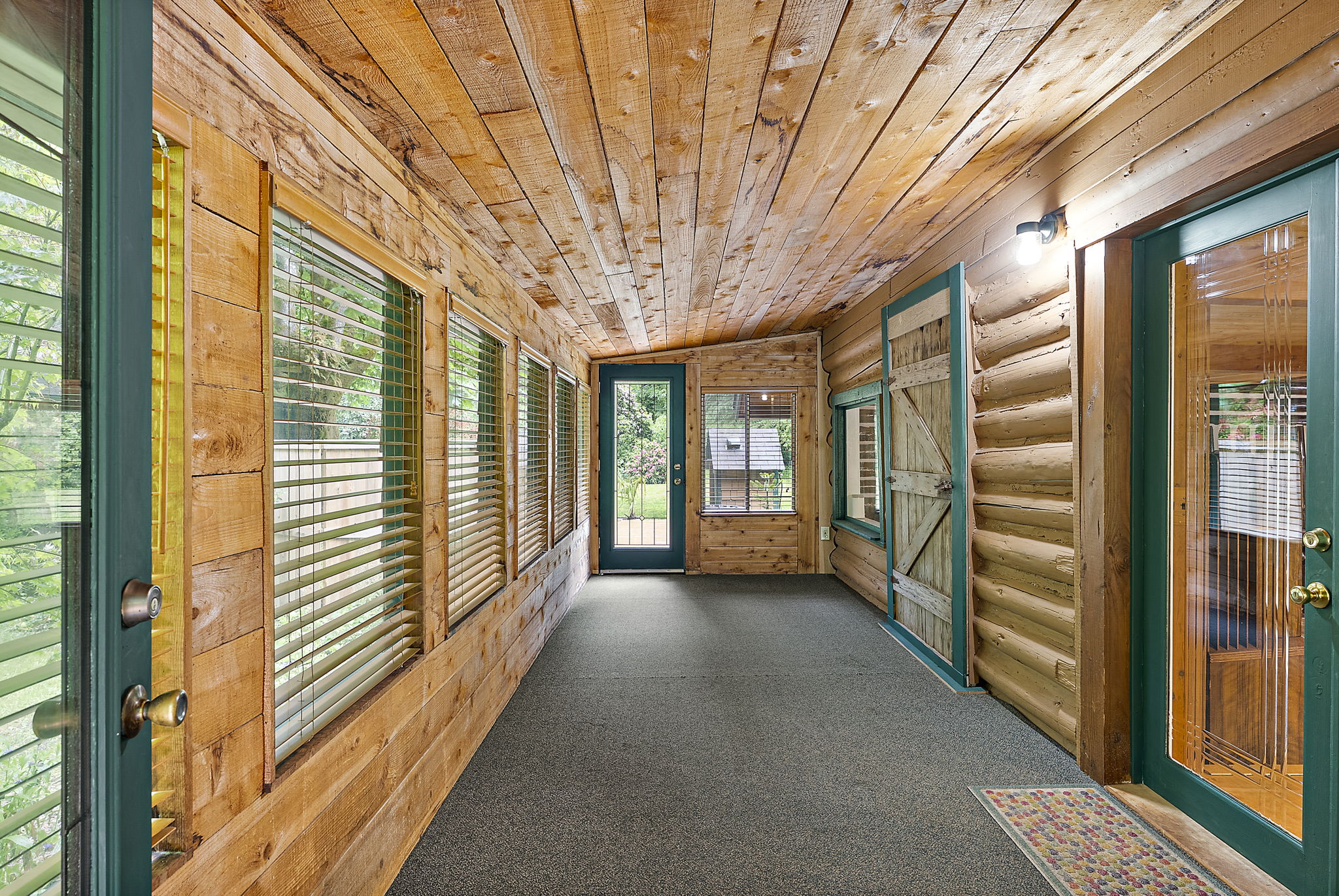 Enclosed porch. On right is double front entry doors into home.