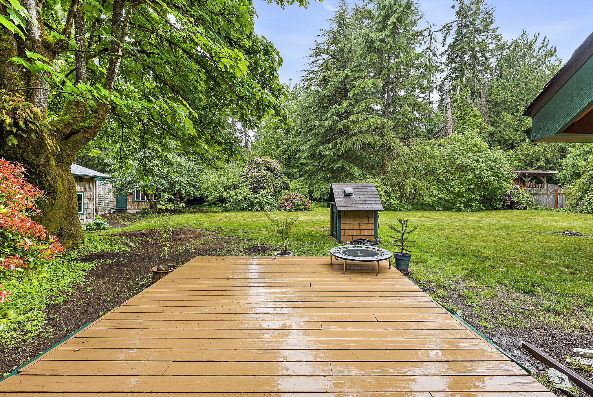 Large deck off the enclosed porch leading to the backyard.