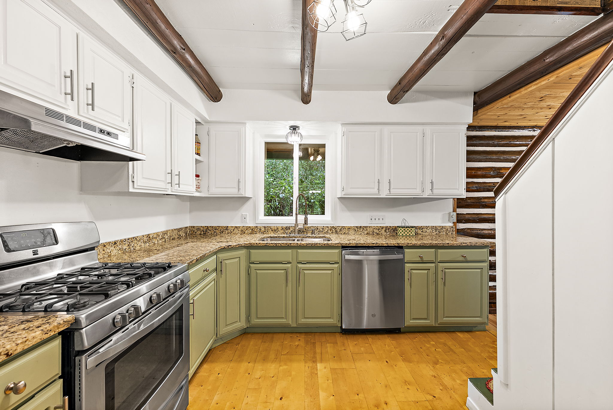 Stainless steel appliance. On the right is the staircase to the upstairs bedrooms. Be sure to check out the walls in the stairway, you're in for a treat!