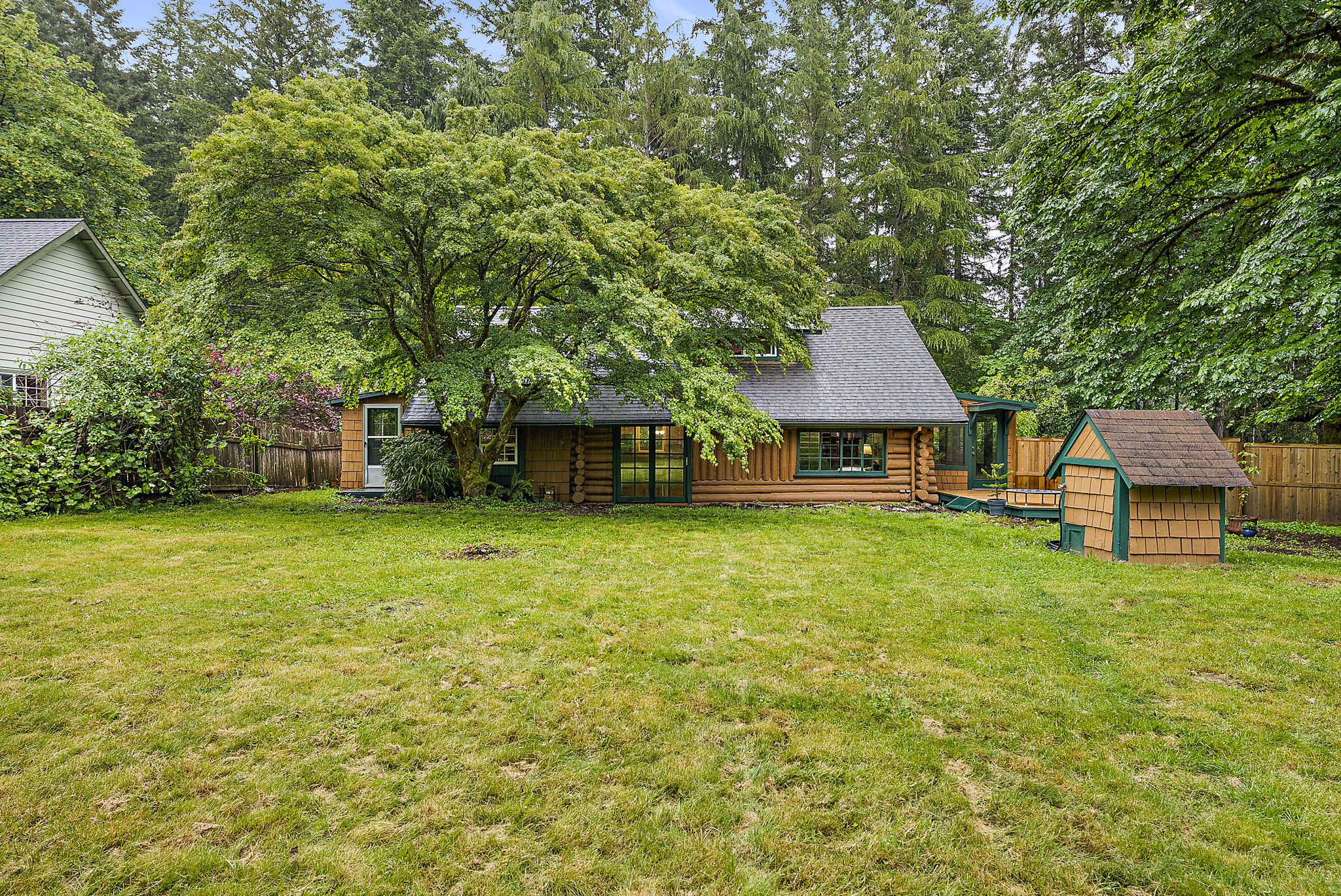 View of back of the home. Little building on the right is the private well.
