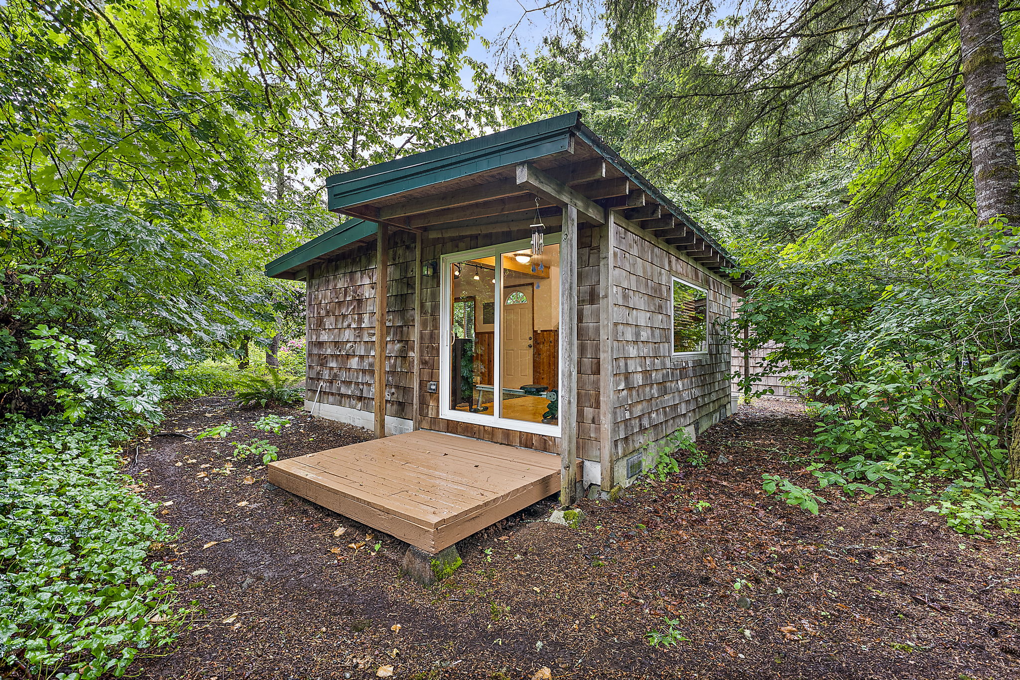 Detached building, currently used as home gym. Has water, electric and a base heater. Patio doors are in the back of the structure.