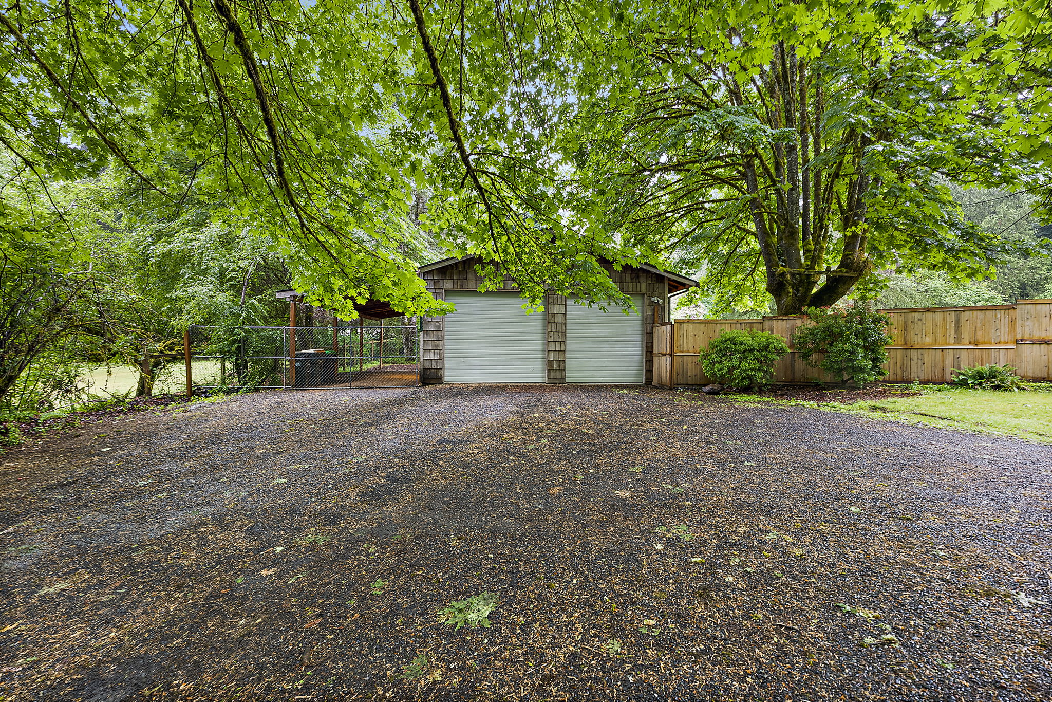 View of detached garage and driveway.