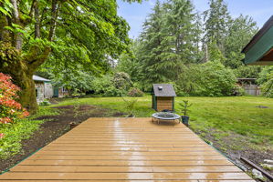 Large deck off the enclosed porch leading to the backyard.