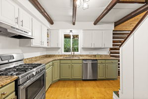 Stainless steel appliance. On the right is the staircase to the upstairs bedrooms. Be sure to check out the walls in the stairway, you're in for a treat!