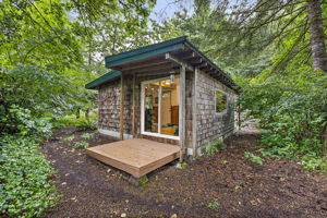 Detached building, currently used as home gym. Has water, electric and a base heater. Patio doors are in the back of the structure.