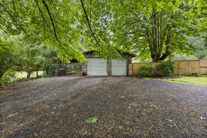 View of detached garage and driveway.