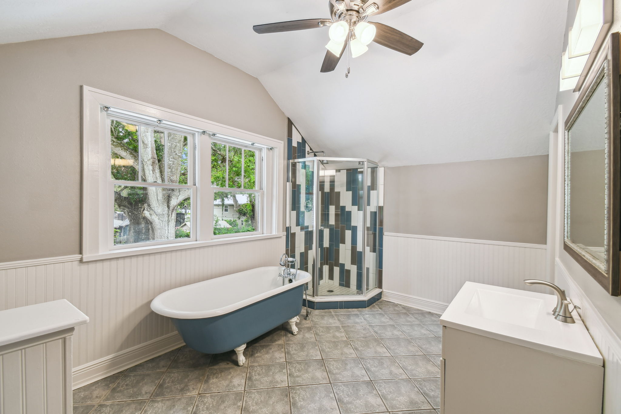 Primary en-suite bath with clawfoot tub and tiled shower