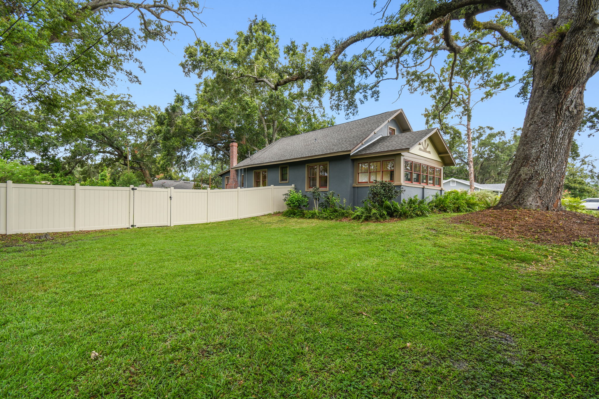 Front side yard is shaded by large oak