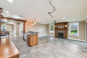 Family room with wood burning fireplace and sconce lighting