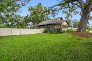 Front side yard is shaded by large oak