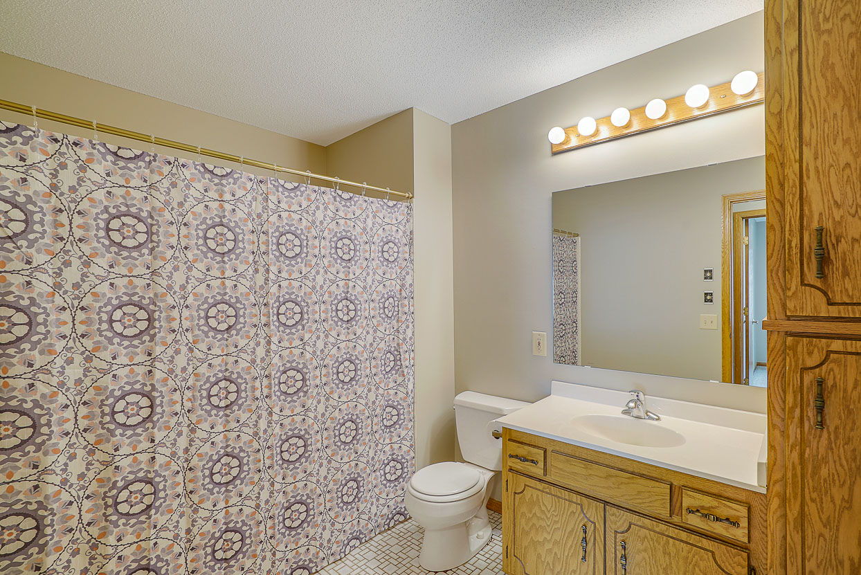 A large Main Bathroom has a jetted tub and Linen Cabinet.