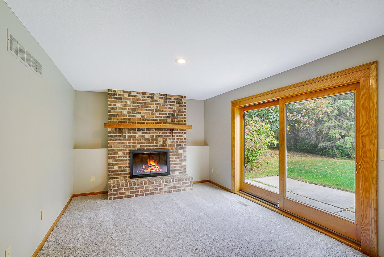 Gather around the Wood-burning Fireplace while viewing your Private Back Yard.