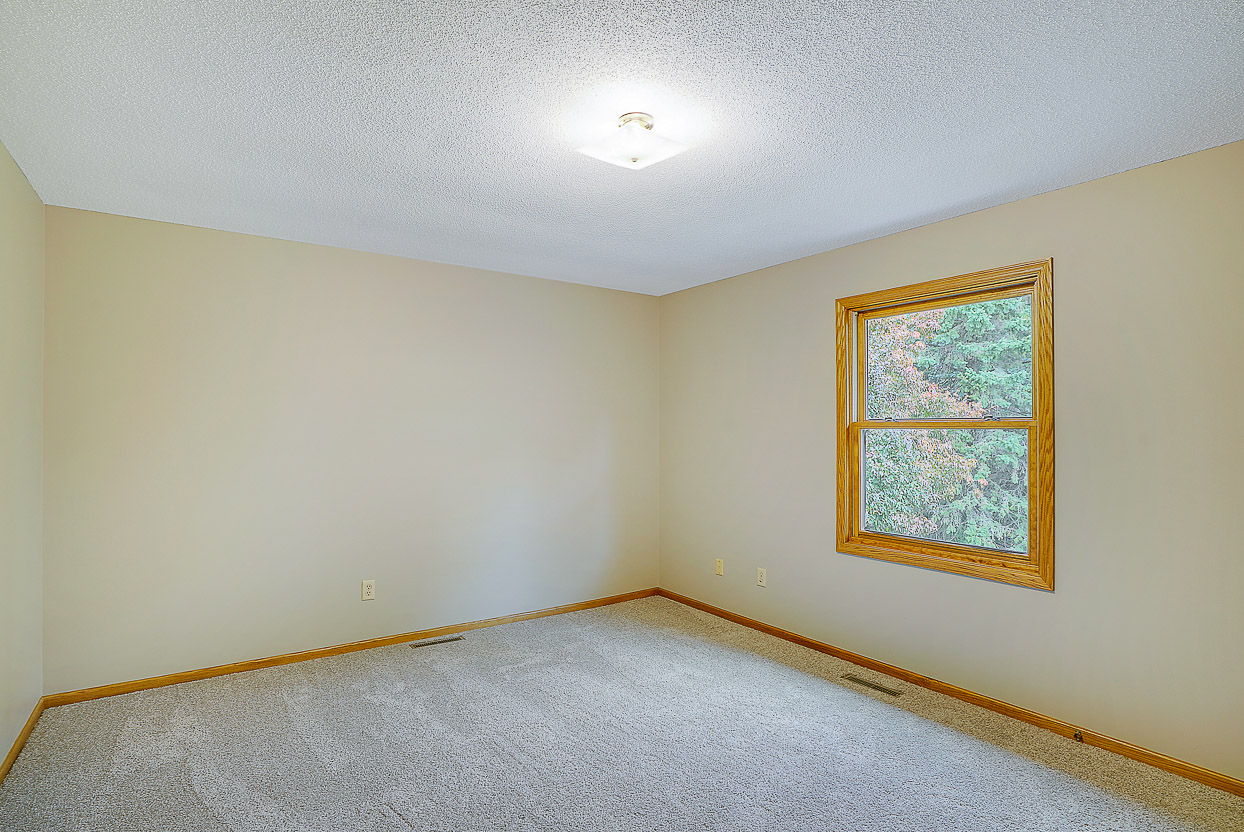 The Large Primary Bedroom overlooks the Backyard.