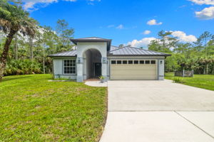 Single-story concrete block home with new metal roof
