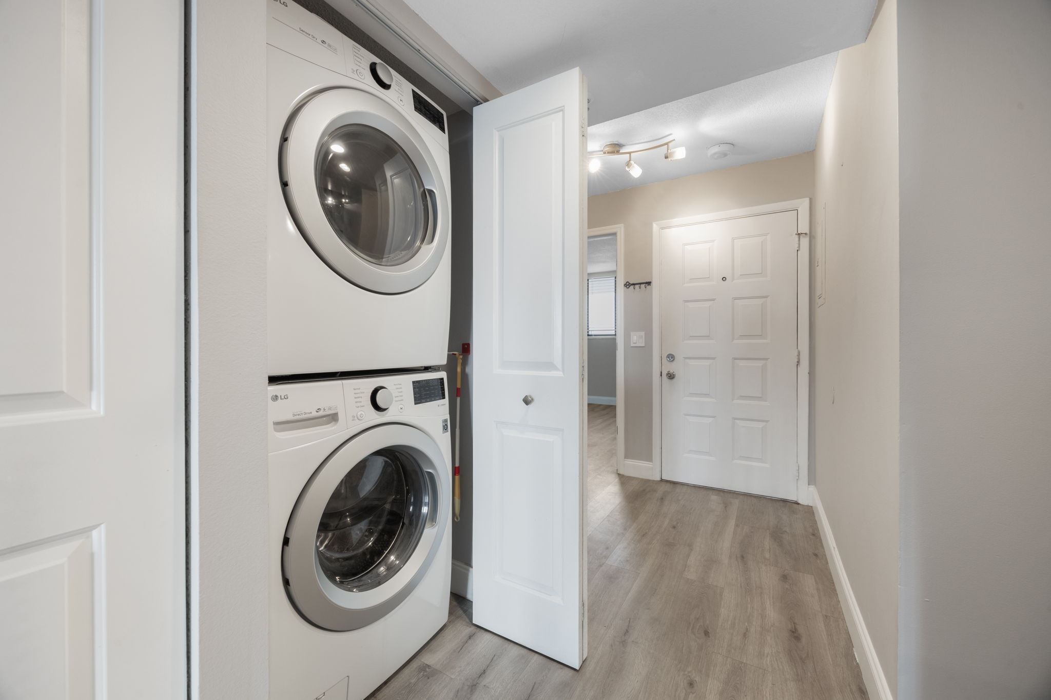 Laundry closet with stackable LG Washer & Dryer included.