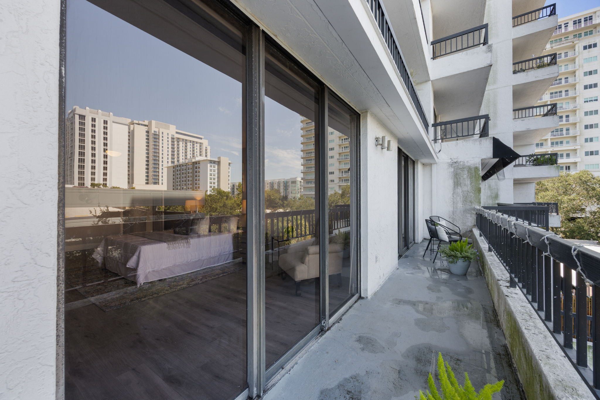 The Balcony of #404. Sliders in the forefront lead to Primary Suite, while those in the background lead to main living area.