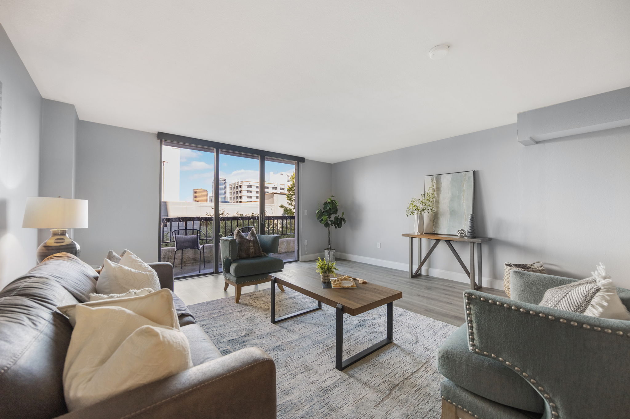 View of living room and balcony- the perfect spot for your evening glass of wine or morning coffee while you take in the city views