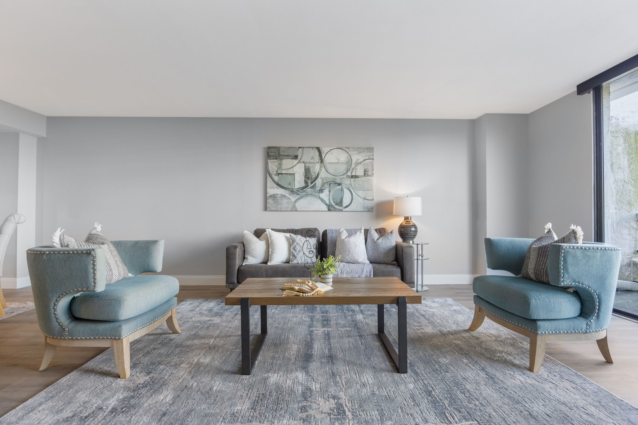 Living room. Freshly painted neutral color palette and abundant natural light create a soothing living space.