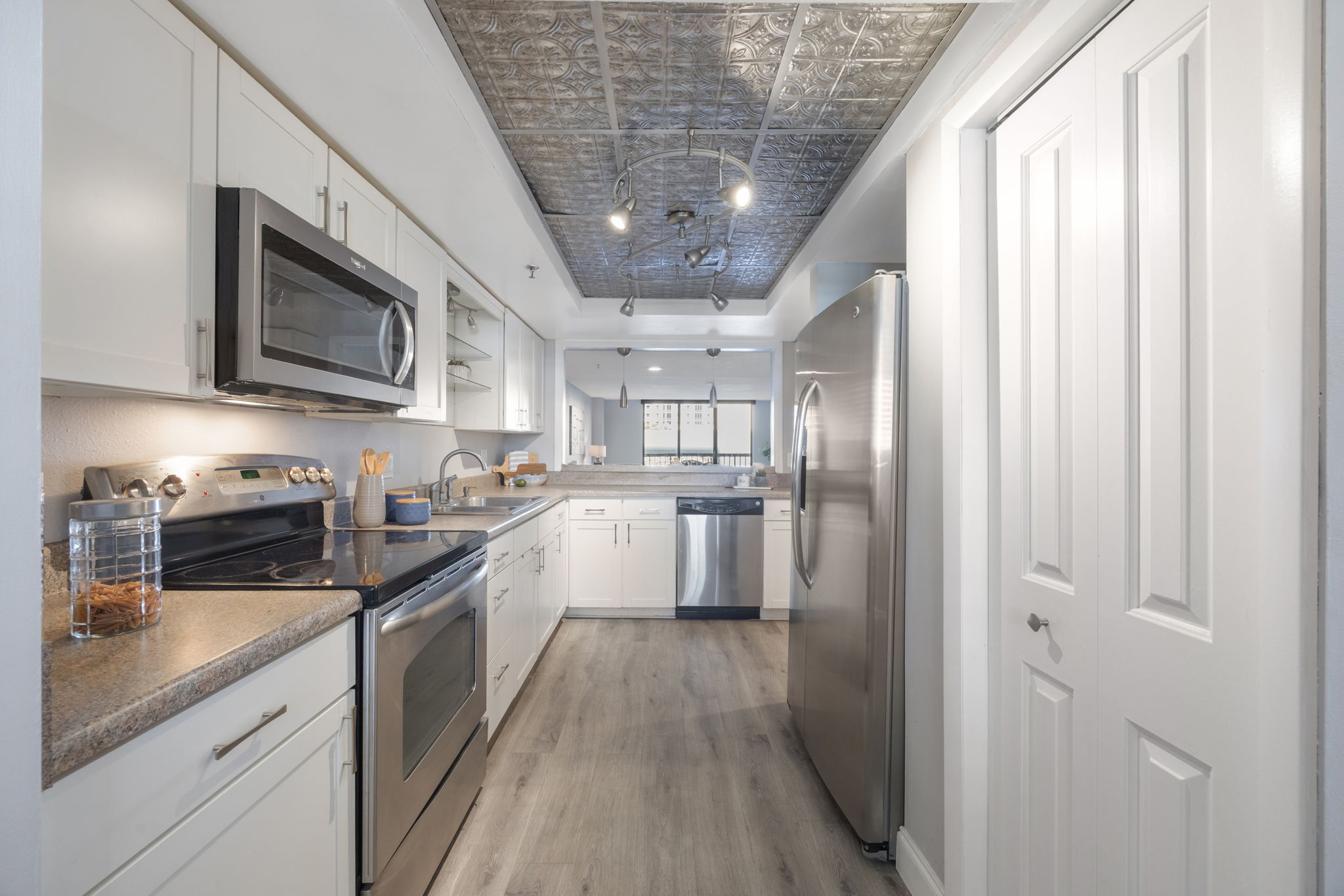 View of the kitchen looking thru to the main dining and living area. The door to the right leads to closet pantry.
