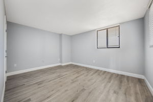 View of the secondary bedroom from the foyer entrance. Split floor plan offers privacy.