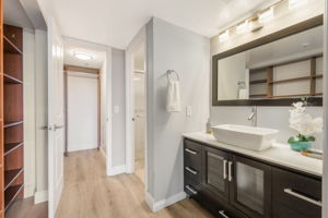 Updated Primary Ensuite. Note the additional built-in storage to the left. Shower and toilet to the right with privacy door and entrance to the walk-in closet in the background.