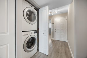 Laundry closet with stackable LG Washer & Dryer included.