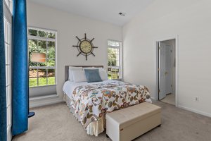 Primary bedroom with privacy and garden views.