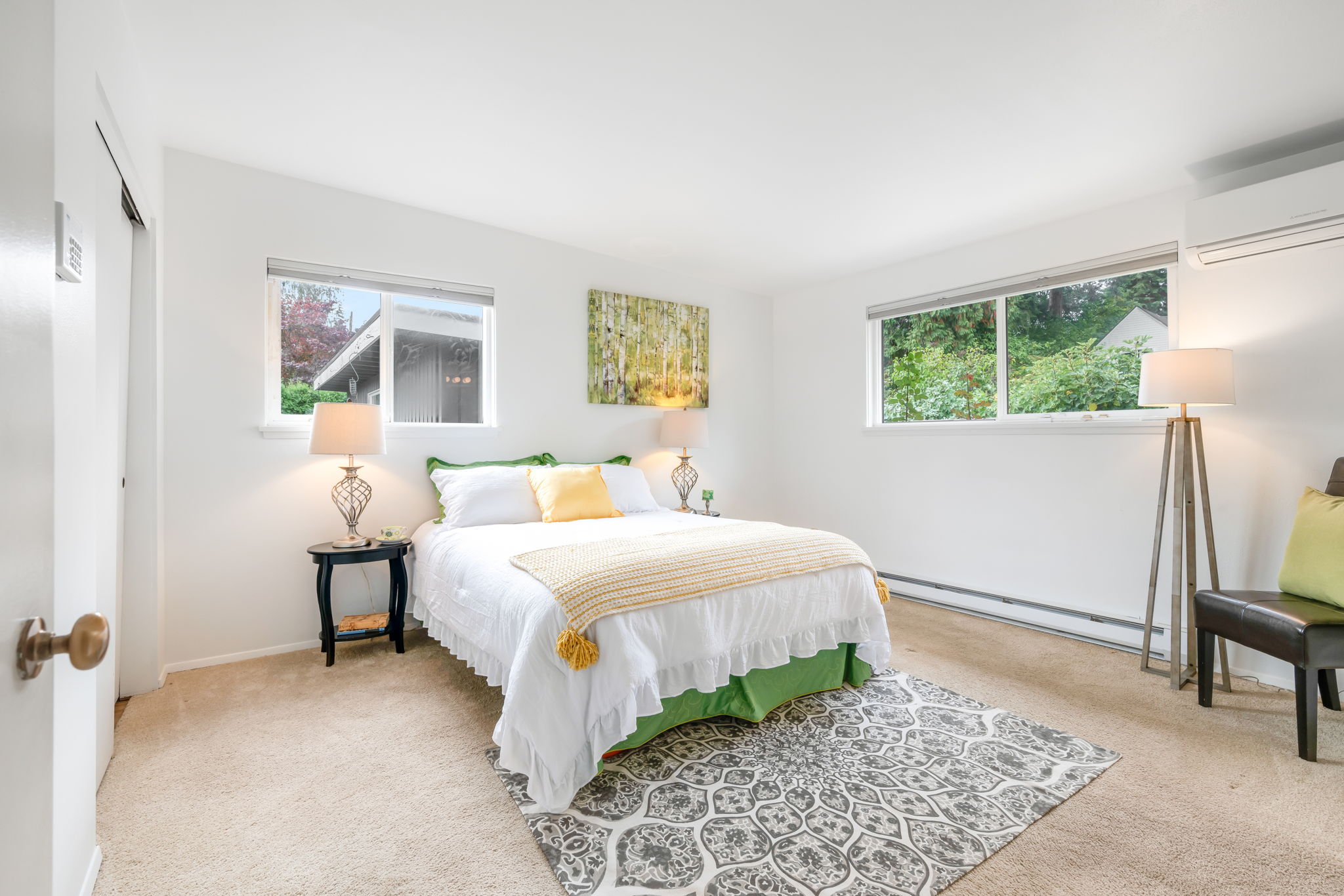 The spacious primary bedroom is a haven of comfort, featuring a double closet and a ductless mini split for year-round climate control.