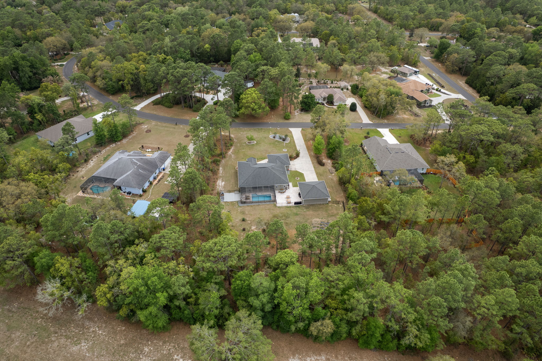 Aerial view of the rear of this home (in the center) and lot.