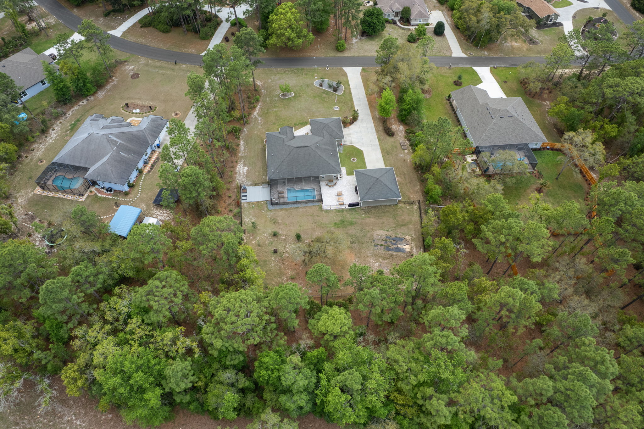 Aerial view of rear of property showing tree coverage.