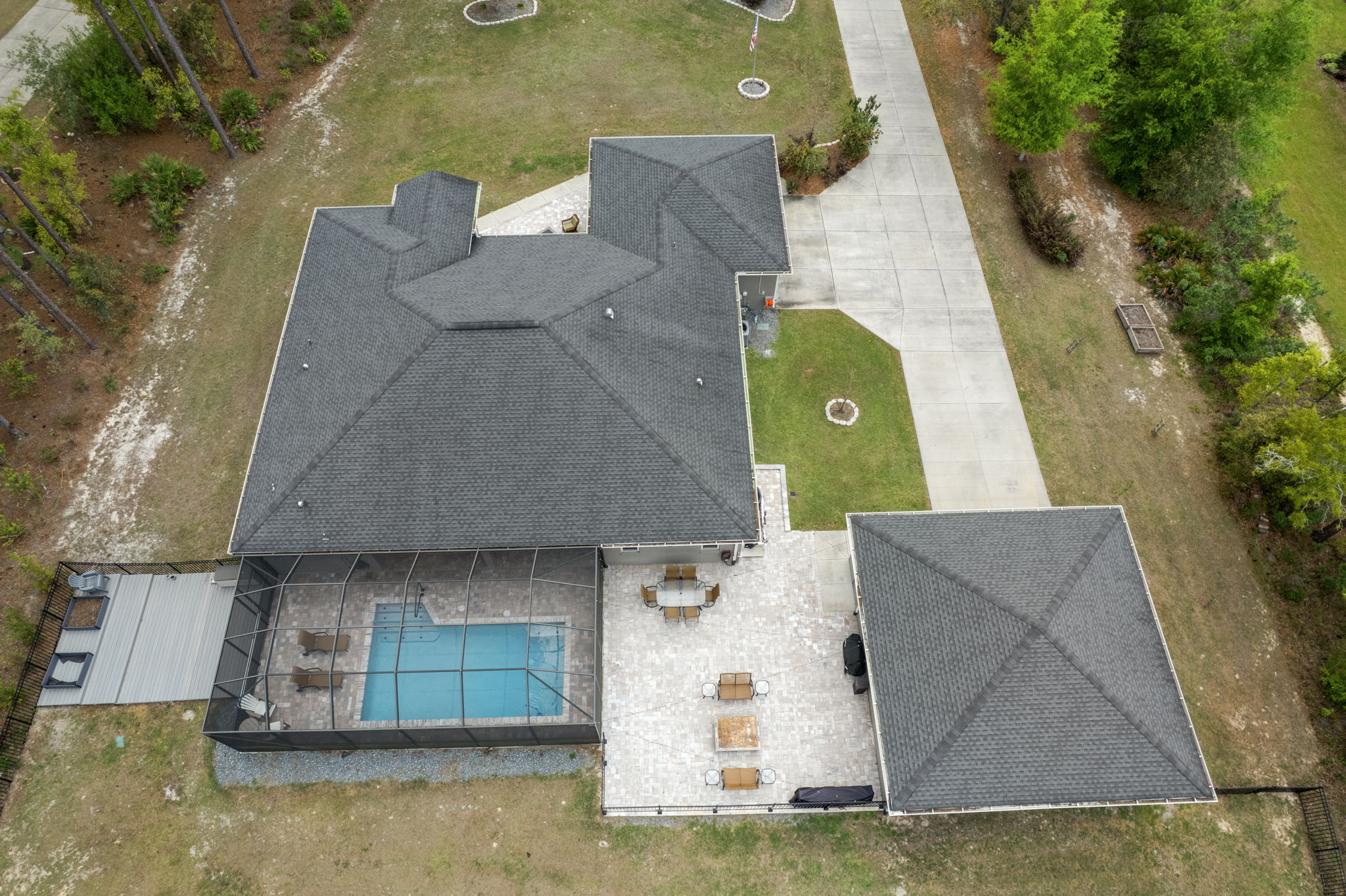 Perfect for outdoor entertaining with a saltwater heated pool, terraced TREX deck on the left, and open patio, complete with firepit on the right.