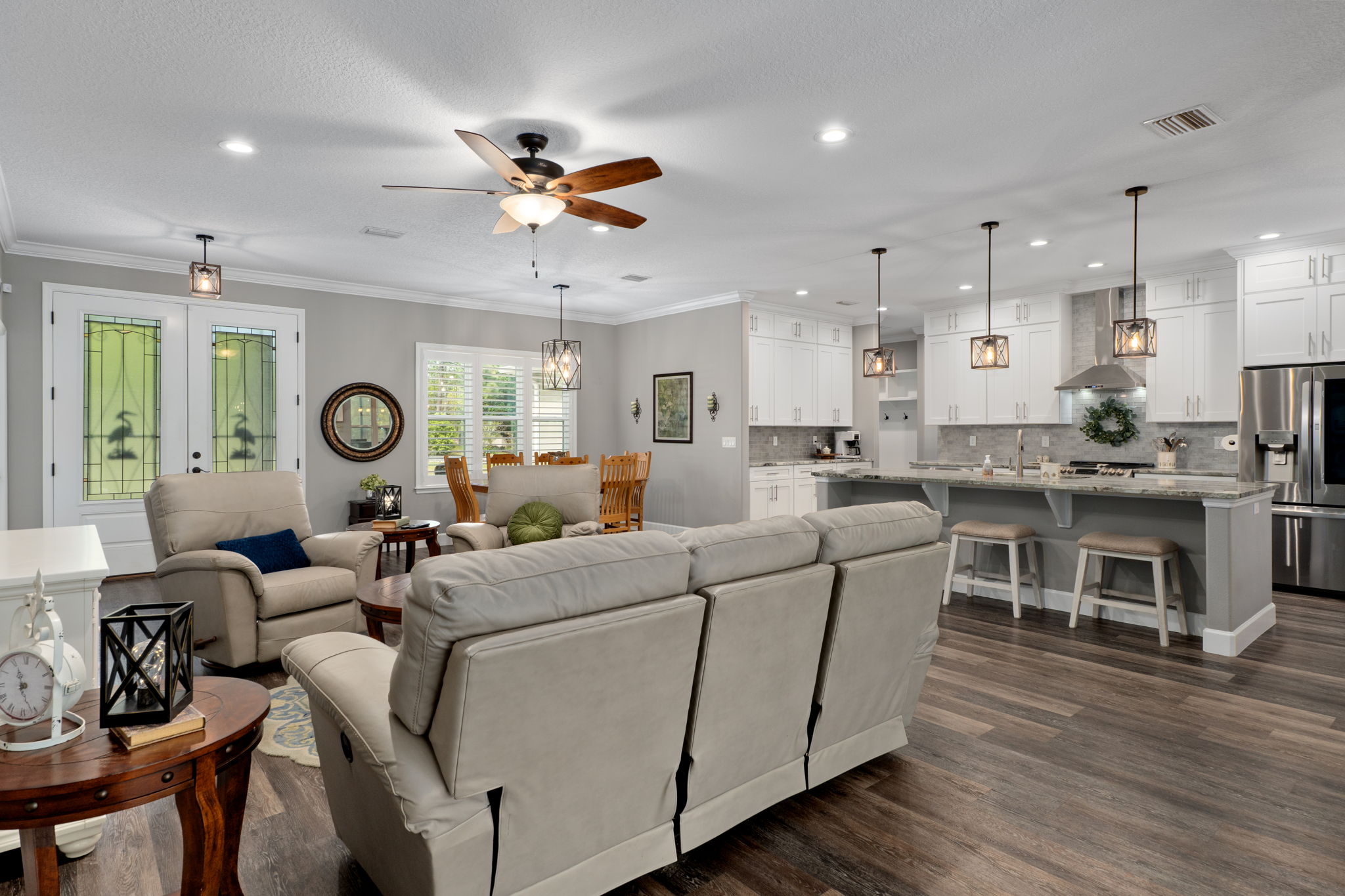 Standing near sliding door looking back toward the front door and across to the kitchen.