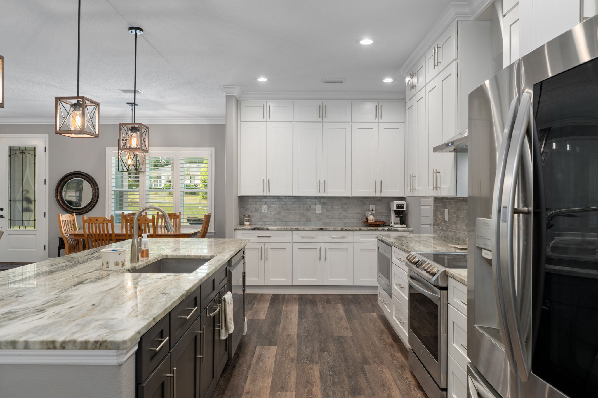 Looking from the breakfast nook, through the kitchen. At the far end, turn right to head to laundry room, mud room hall, and walk-in pantry.