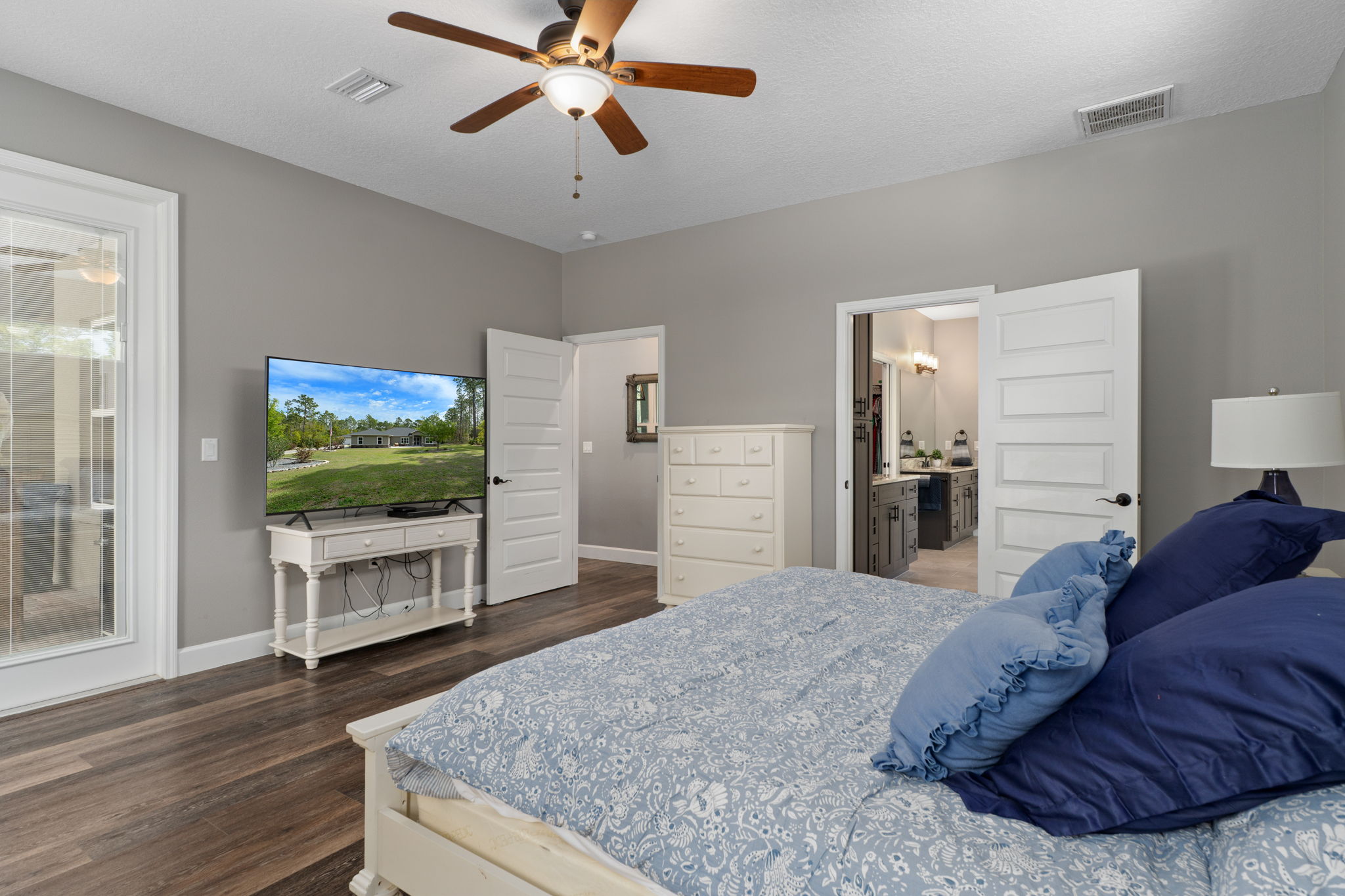 Opposite view of primary bedroom. Doorway in center leads out to great room. The door to the right of center leads to the primary bath and walk-in closet.