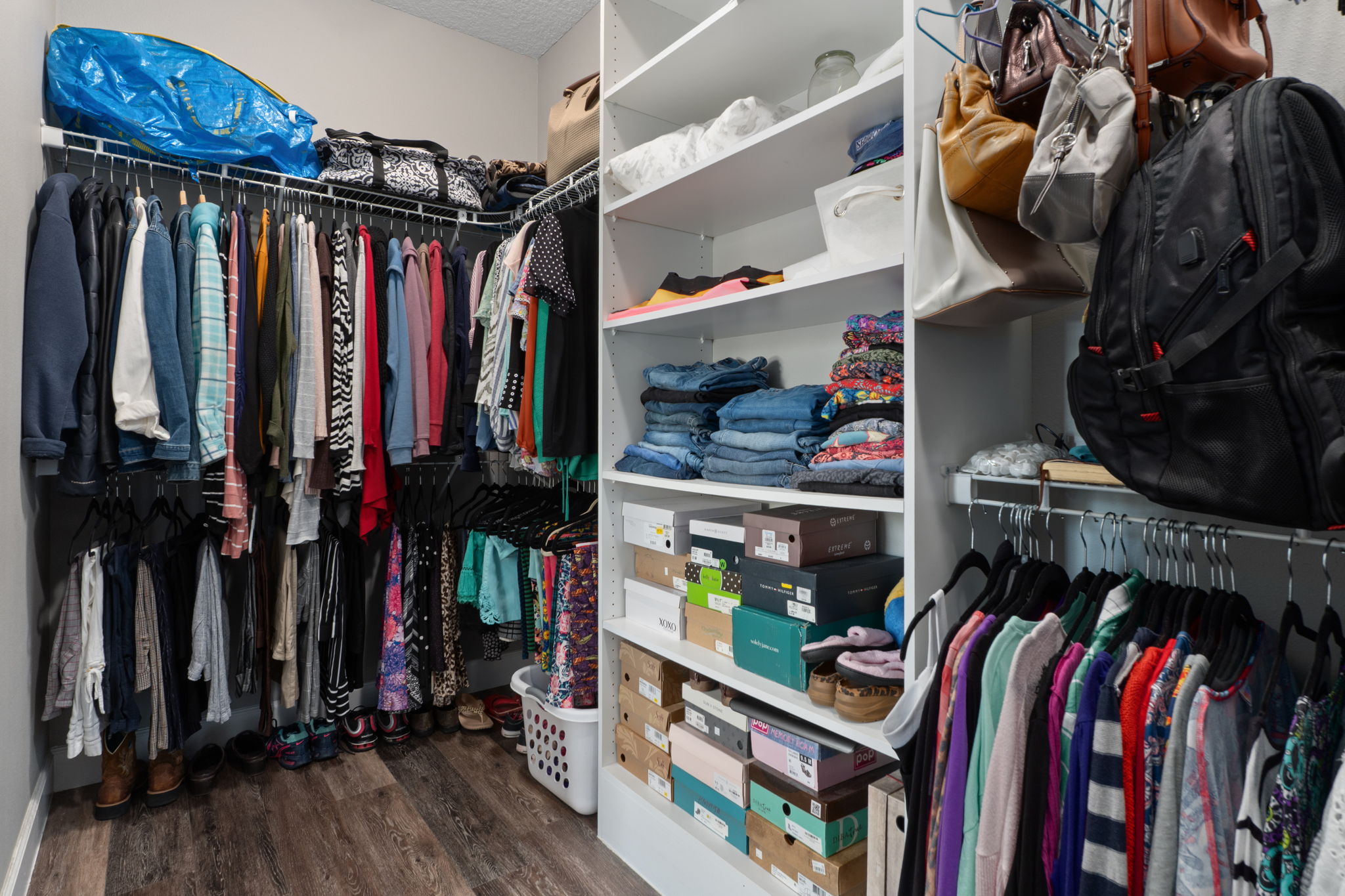 The oversized primary suite closet is 12'10" long and is separated from the bath with a pocket door.