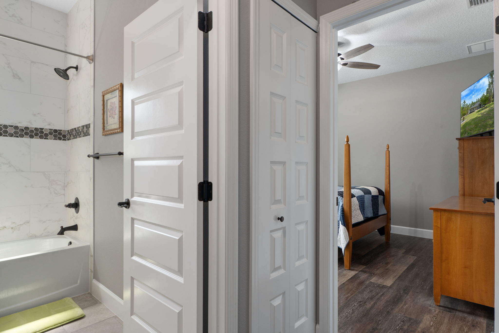 Upon entering the guest wing hall, the hall bath is situated between the two bedrooms.